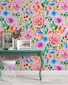 the wallpaper is colorful and has flowers painted on it, as well as a small table