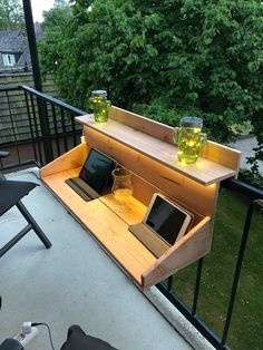 an open laptop computer sitting on top of a wooden shelf