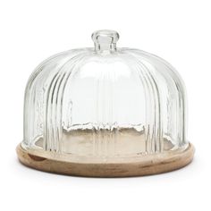 a glass dome with wooden base on a white background