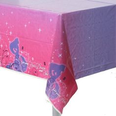 the table cloth is pink and purple with princess silhouettes on it's side