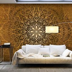 a living room with a couch, lamp and wallpaper on the walls that has an intricate design