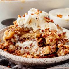 a close up of a plate of food with ice cream and pecans on top