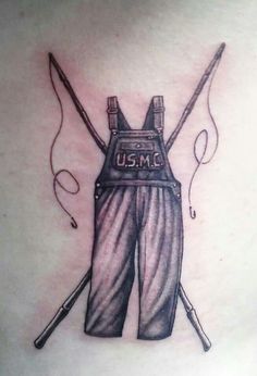 the back of a woman's chest with two crossed swords and an army vest on it