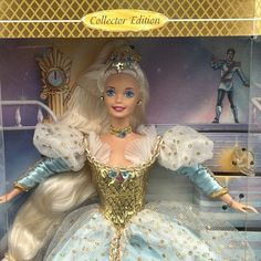 a barbie doll in a box with an elaborate dress and tiara