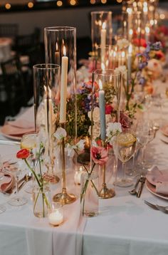 the table is set with candles and flowers