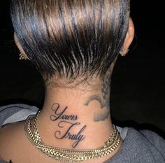 the back of a woman's neck with her name tattooed on it