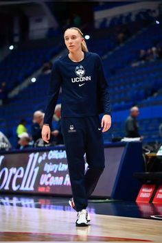 a woman standing on top of a basketball court