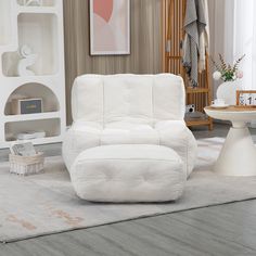 a white chair and ottoman in a living room