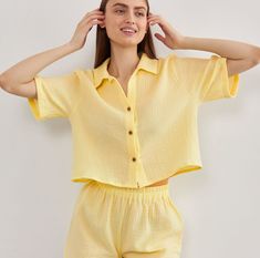 Unveil a fresh, contemporary look with our Muslin Shirt featuring Short Sleeves. Exquisitely crafted from crinkle cotton, this Crop Blouse for women offers a relaxed yet chic appearance, making it a must-have for every fashion-forward wardrobe. The gauzy texture accentuates its breezy nature, ensuring maximum comfort during those warm days. This Gauze Loose Top, with its delicate button details and flattering cut, is perfect for pairing with jeans, skirts, or shorts.  * Made from European muslin (100% cotton) * OEKO-TEX certified fabric (no harmful chemicals used in production) * From XS to Plus size TAKING CARE: * machine wash gentle (30- 40 C/ 104 F) * dry gentle. * do not bleach. Each order is sewn with love and attention to detail especially for you. Spring Cotton Top With Crinkle Texture, Spring Linen Tops With Crinkle Texture, Spring Cotton Crinkle Texture Top, Linen Blouse With Crinkle Texture, Chic Cotton Tops With Crinkle Texture, Spring Cotton Blouse With Crinkle Texture, Summer Cotton Shirt With Crinkle Texture, Summer Cotton Blouse With Crinkle Texture, Cotton Crinkle Texture Top For Vacation