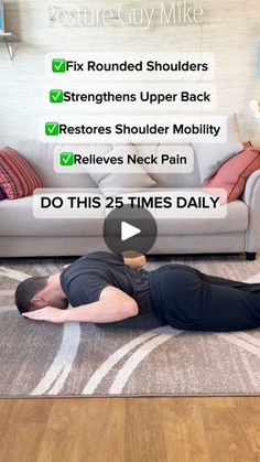 a man laying on the floor in front of a couch with his back turned to the camera