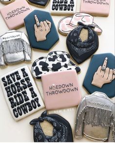 some decorated cookies are on a table with the words save horse ride cowboy written on them