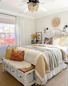 a bedroom with a white bed and lots of pillows