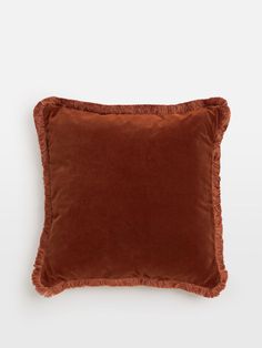 a brown pillow with ruffled edges