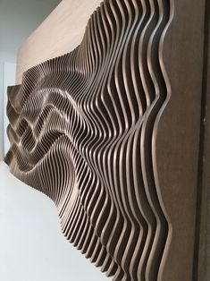 an abstract wooden sculpture is shown in this photo