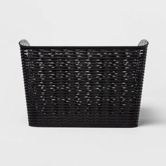 a large black basket with handles on the top and bottom, sitting in front of a white background