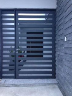 an image of a gate that is on the side of a building with black slats