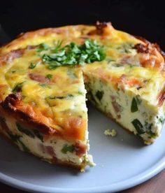 a quiche on a plate with one slice missing