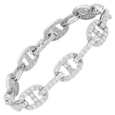 Introducing our exquisite 4.90 Carat Diamond Chain Link Bracelet in 18K White Gold. This bracelet is a true testament to luxury and sophistication. Featuring oval links encrusted with a magnificent 4.90 carats of diamond pave, it radiates brilliance and captivates attention. The chain link construction not only adds an elegant touch but also ensures extreme comfort, allowing the bracelet to drape effortlessly on your arm. Whether you want to make a bold statement or prefer a more subtle look, th Modern Bracelets, American Modern, Diamond Chain, Look Plus, Chain Link Bracelet, Modern Jewelry, Pave Diamonds, Link Bracelets, Diamond White