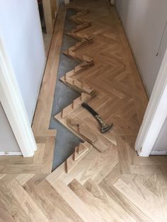 a wooden floor that has been stripped off and laying on the ground next to an open door