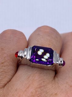 Vintage Handmade Genuine Purple Amethyst Filigree Setting 925 Sterling Silver Gothic Ring Unusual Amethyst  Ring set with tiny red crystals  Sterling Filigree Setting Handmade  Size 7.5 can be re sized for you.  My jeweler charges $20 Sterling Silver is rhodium finished to prevent tarnish All rings are shipped in a nice gift box.   Check out our over a THOUSAND great reviews Engraving is $4 per letter and is not always perfect depending on the piece. It can take a few days if the jeweler is busy Sterling Silver Amethyst Ring With Gemstone Accents For Anniversary, Anniversary Sterling Silver Amethyst Ring With Gemstone Accents, Anniversary Amethyst Ring With Gemstone Accents In Sterling Silver, Gift Amethyst Ring With Gemstone Accents, Sterling Silver Jewelry With Rectangular Center Stone, Collectible Silver Jewelry With Gemstone Accents, Silver Ruby Ring With Gemstone Accents, Silver Jewelry With Gemstone Accents For Collectors, Unique Ruby Jewelry With Accent Stones