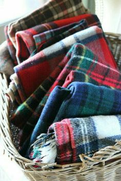 a basket filled with blankets sitting on top of a table