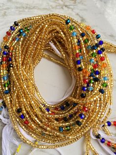 "FREE SHIPPING Please Note: **We have different options, please scroll to see options or message if you want even MORE OPTIONS **These waist beads ship from Ghana, West Africa. They are traditional and authentic yet fancy and fashionable.* **Shipping takes 3-5 days to be delivered or longer based on processing time. **Payment method: PayPal (Message for email) #Waist beads sizes vary from 35\"-45\" #They are all made with cotton threads #Bead sizes vary from 6/0, 8/0 12/0 Package options: Packag Bohemian Waist Beads With Tiny Beads For Party, Bohemian Multicolor Waist Beads With Gold Beads, Traditional Party Waist Beads, Bohemian Waist Beads With Spacer Beads For Party, Bohemian Waist Beads For Parties With Spacer Beads, Bohemian Gold Waist Chain With Colorful Beads, Gold Bohemian Waist Chain With Colorful Beads, Bohemian Beaded Gold Waist Chain, Bohemian Gold Beaded Waist Chain