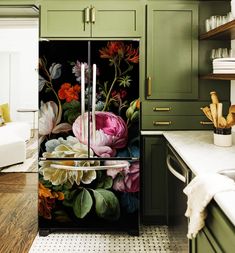 a kitchen with green cabinets and painted flowers on the door