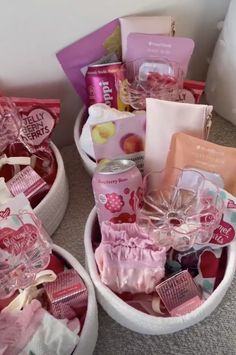 two baskets filled with lots of different types of items on the floor next to each other