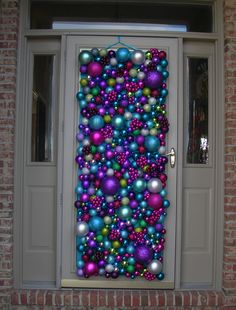 a door decorated with christmas ornaments and balls