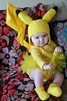 a baby in a pikachu costume sitting on a couch