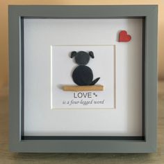 a shadow frame with a dog on it that says love is a four legged word