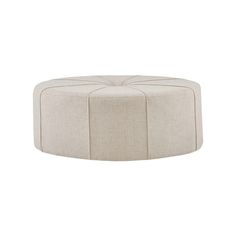 a round ottoman that is made out of fabric