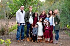 a family posing for a photo in the woods