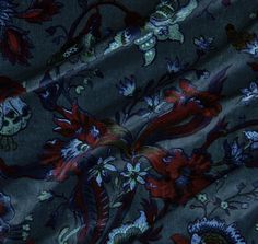 a blue and red floral print fabric with skulls on the side, surrounded by flowers