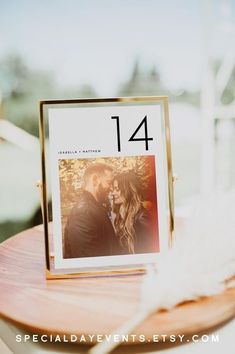 a wooden table topped with a photo frame