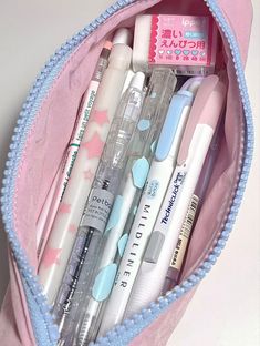 a pink bag filled with lots of different types of pens