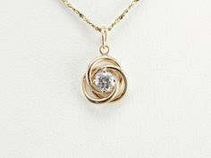 A high quality stone combines perfectly with the highly polished yellow gold in this vintage knot pendant. Perfect for everyday, this would make a lovely little sweetheart piece, as well! This pendant does not come with the chain shown. Please feel free to contact us, we will help you find the perfect chain for your style and budget! Metal: 14K Yellow Gold Gem: Diamond .32 Carats, SI2 in Clarity, H in Color Gem Measurements: 4.2 mm, Round Measures: 10 x 16 mm, with bail Delicate Silver Necklace, Solitaire Diamond Pendant, Gold Necklace Simple, Solitaire Necklace, Gifts For Your Sister, Round Necklace, Solitaire Necklaces, Diamond Pendant Necklace