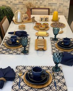 the table is set with blue dishes and place mats