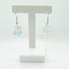 🌊 Sea Glass and Czech Crystal Earrings - Coastal Jewelry 🌊 Indulge in the serene allure of our meticulously handcrafted sea glass and Czech crystal earrings, where the beauty of the ocean meets the sparkle of crystal clarity. Each pair is meticulously handcrafted to capture the essence of coastal charm, showcasing unique sea glass pieces delicately paired with shimmering Czech crystals. Key Features: Handcrafted Excellence: Meticulously crafted for quality and uniqueness. Coastal Charm: Perfec Minimalist Beach Jewelry With Ear Wire, Minimalist Handmade Earrings For Beach, Sea Glass Teardrop Earrings As Gift, Elegant Jewelry With Sea Glass And Ear Wire, Minimalist Sea Glass Jewelry For Beach, Teardrop Sea Glass Earrings For Gift, Clear Glass Jewelry For Beach, Sea Glass Teardrop Earrings For Beach, Elegant Sea Glass Jewelry With Ear Wire