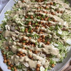 a large salad with dressing on top of it