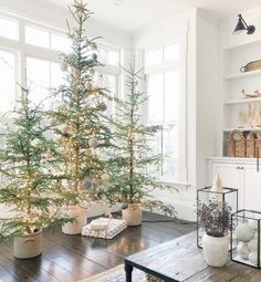 a living room with a christmas tree in the corner and other decorations on the table