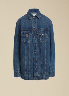 a denim jacket hanging on a hanger