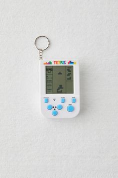 a gameboy keychain hanging on the wall