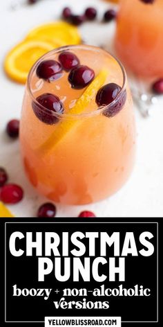 christmas punch with orange slices and cranberries on the rim, garnished with cherries