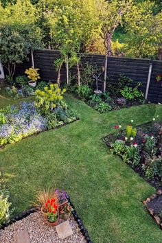 a garden with lots of different types of flowers and plants in the middle of it