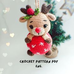 a crocheted christmas ornament with a reindeer holding a heart on it