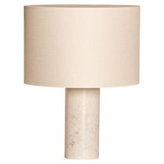 a white table lamp with a beige shade