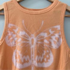 New Hollister Ribbed Orange Butterfly Tank Size Large Color: Orange, Peach Size: Large (L) Condition: New With Tags (Nwt) Adorable High Neck Crop Tank From Hollister. Casual Orange Seamless Tops, Orange Ribbed Summer Tops, Orange Ribbed Tops For Spring, Orange Butterfly, Hollister Tops, Pumpkin Orange, Crop Tank, Color Orange, Hollister