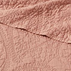 the texture of an old pink quilt