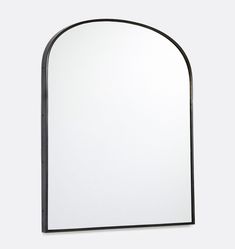 an arch shaped mirror is shown against a white background with black trimmings on the edges